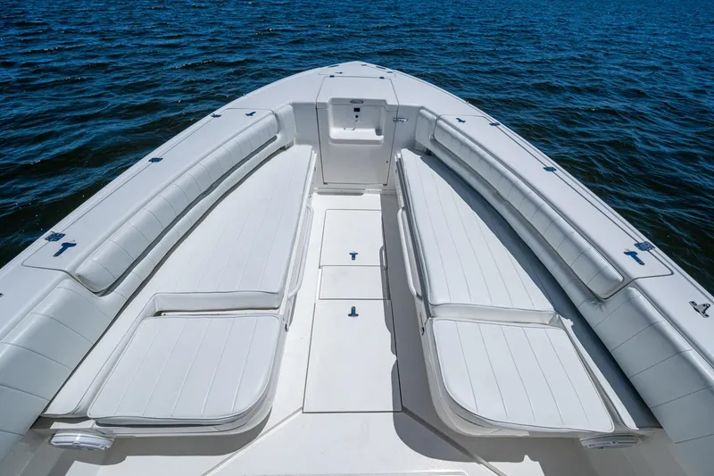 Slide: The Image of 2010 Intrepid 323 OPEN boat with spacious white seating on calm water. - 25