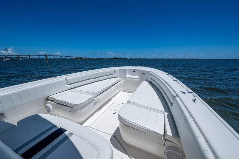 Slide: The Image of 2010 Intrepid 323 OPEN boat interior with white seating, on a sunny day at sea. - 27