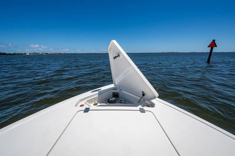 Slide: The Image of 2010 Intrepid 323 OPEN boat on water, open hatch, clear blue sky. - 29
