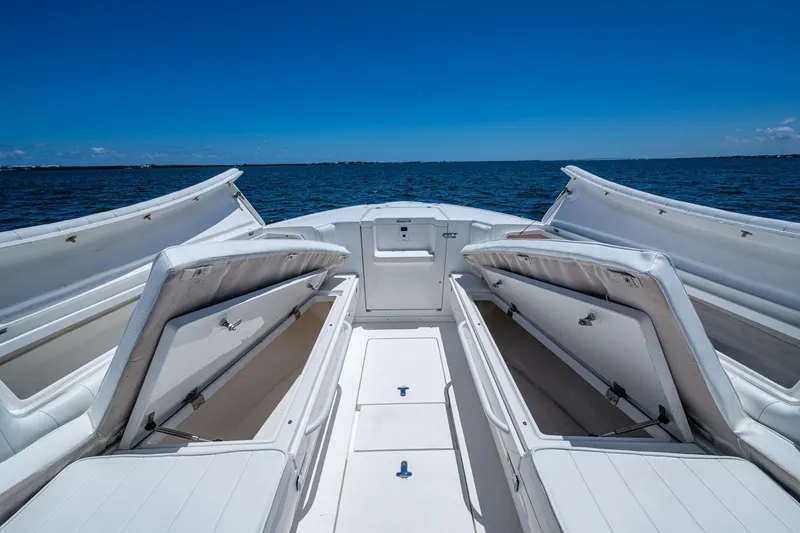 Slide: The Image of 2010 Intrepid 323 OPEN boat with open storage compartments on a sunny day at sea. - 31
