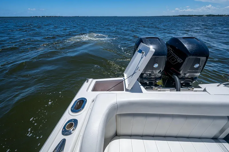 Slide: The Image of 2010 Intrepid 323 OPEN boat with dual outboard engines on open water. - 34