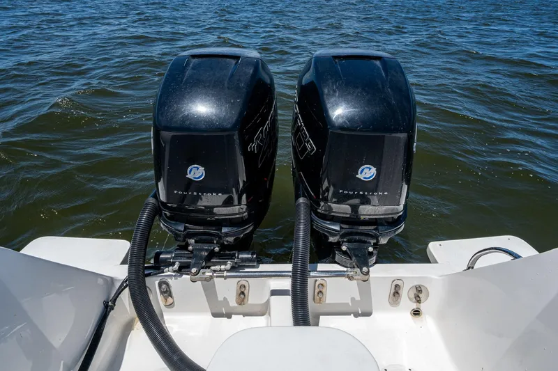 Slide: The Image of Twin outboard motors on a 2010 Intrepid 323 OPEN boat in open water. - 35