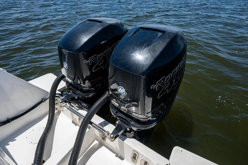 Slide: The Image of Twin outboard motors on a 2010 Intrepid 323 OPEN boat in water. - 37