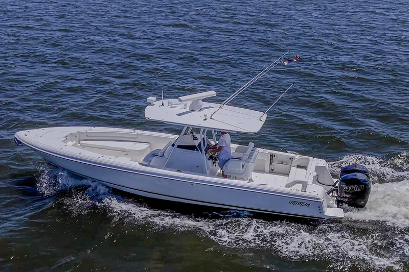 Slide: The Image of 2010 Intrepid 323 OPEN boat cruising on open water, side view. - 4