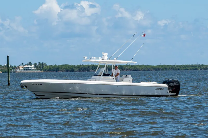 Slide: The Image of 2010 Intrepid 323 OPEN boat cruising on a sunny day with clear skies. - 7