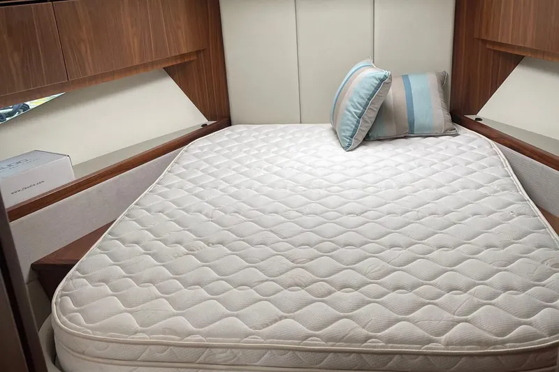 Slide: The Image of Luxurious bedroom in 2020 Riviera 4800 Sport Yacht with plush mattress and pillows. - 14