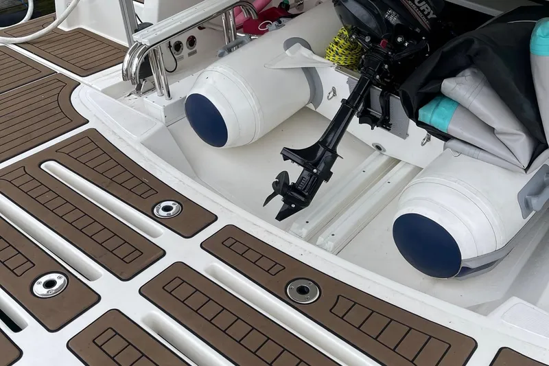 Slide: The Image of Riviera 4800 Sport Yacht 2020 deck with inflatable boat and outboard motor. - 7