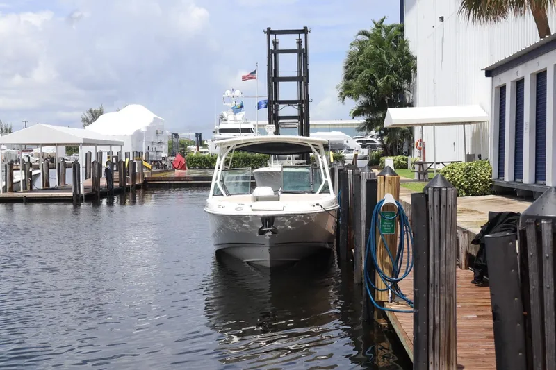 Slide: The Image of 2017 Boston Whaler 270 Vantage docked at marina with clear skies. - 14