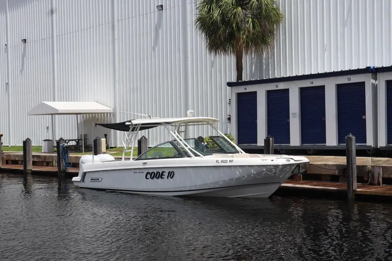 Slide: The Image of 2017 Boston Whaler 270 Vantage boat docked near storage units. - 15