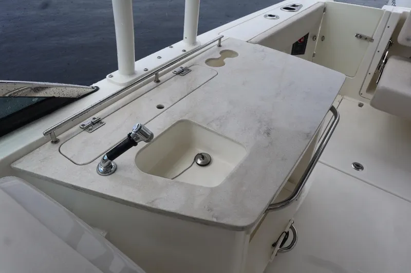 Slide: The Image of 2017 Boston Whaler 270 Vantage boat interior with sink and countertop. - 9
