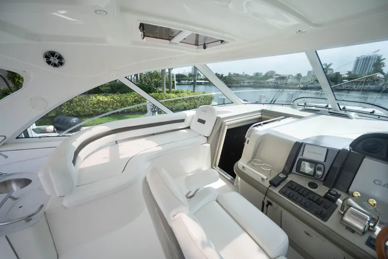 Slide: The Image of 2006 Sea Ray 48 Sundancer yacht interior with helm, seating, and navigation equipment. - 10