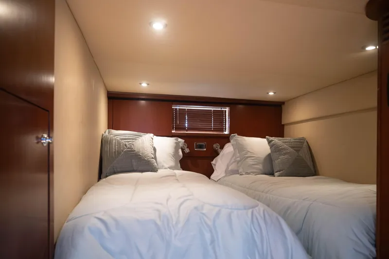 Slide: The Image of Interior cabin of 2006 Sea Ray 48 Sundancer with twin beds and cozy lighting. - 16