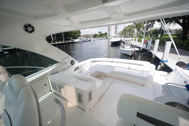 Slide: The Image of Luxurious 2006 Sea Ray 48 Sundancer yacht interior with spacious seating and waterfront view. - 6