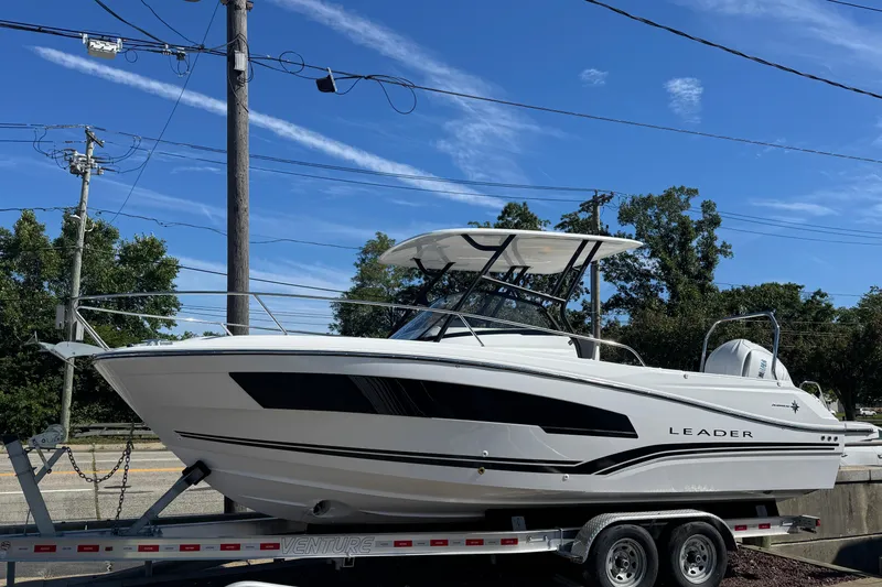 The Image of 2026 Jeanneau Leader WA 7.5 boat on trailer under clear blue sky. - 1