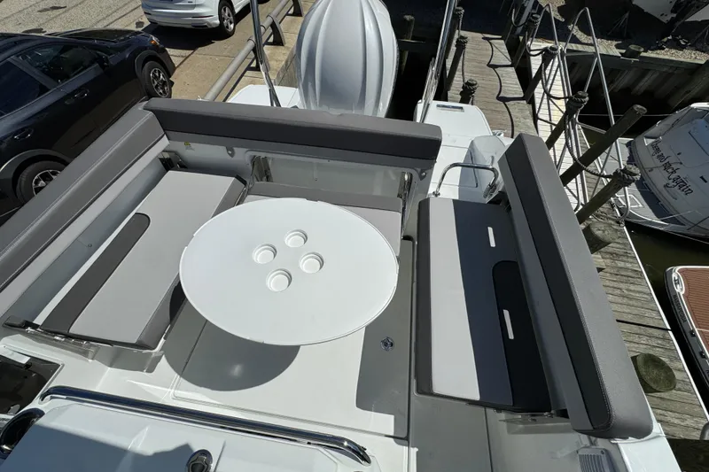 Slide: The Image of 2026 Jeanneau Leader WA 7.5 boat interior with seating and round table. - 12