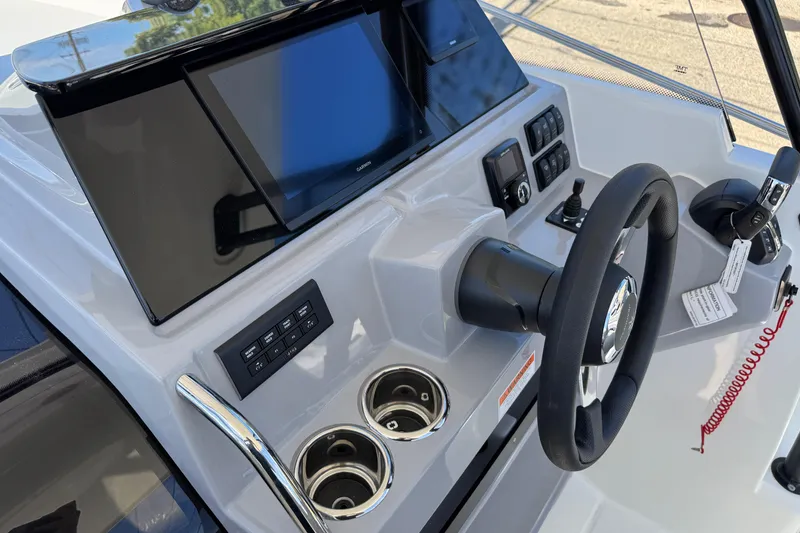 Slide: The Image of 2026 Jeanneau Leader WA 7.5 boat dashboard with steering wheel and control panel. - 13