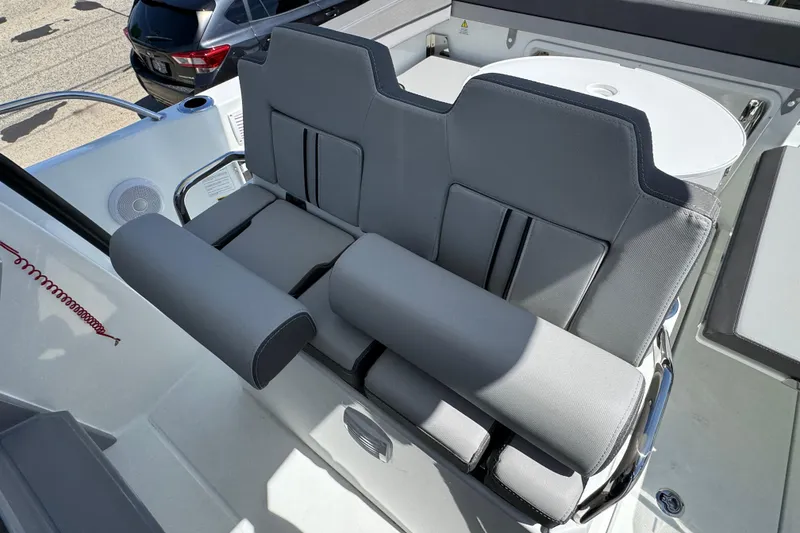 Slide: The Image of 2026 Jeanneau Leader WA 7.5 boat seating area with gray upholstery and modern design. - 14