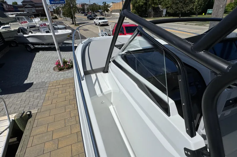 Slide: The Image of 2026 Jeanneau Leader WA 7.5 boat displayed at a dealership, showcasing sleek design. - 18