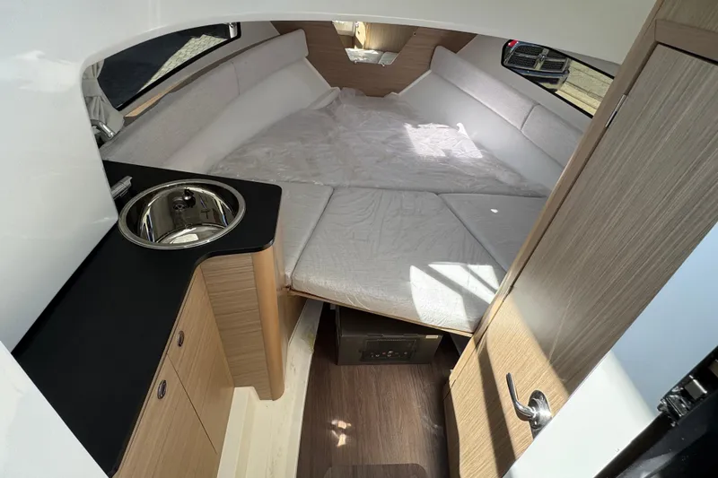 Slide: The Image of Interior of 2026 Jeanneau Leader WA 7.5 boat with bed and sink. - 22