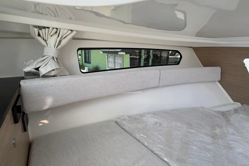 Slide: The Image of Interior cabin of 2026 Jeanneau Leader WA 7.5 with window and cushioned seating. - 24