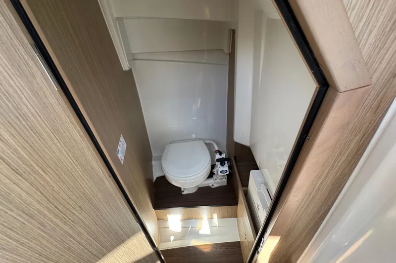 Slide: The Image of 2026 Jeanneau Leader WA 7.5 boat interior bathroom with modern design and wooden accents. - 28