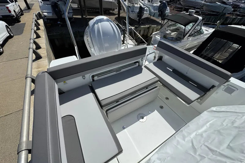 Slide: The Image of 2026 Jeanneau Leader WA 7.5 boat interior with gray seating and modern design. - 4