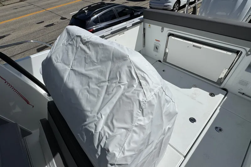 Slide: The Image of 2026 Jeanneau Leader WA 7.5 boat interior with covered seating and storage compartments. - 7