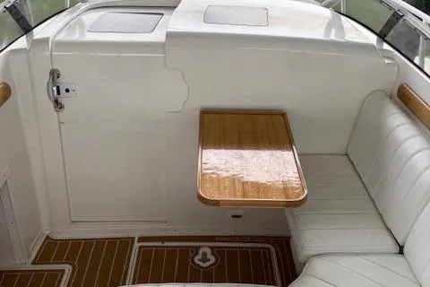 Slide: The Image of 2006 Intrepid 310 Walkaround interior with white seating and wooden table. - 21