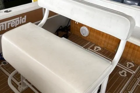 Slide: The Image of 2006 Intrepid 310 Walkaround interior with white seating and wooden table. - 22