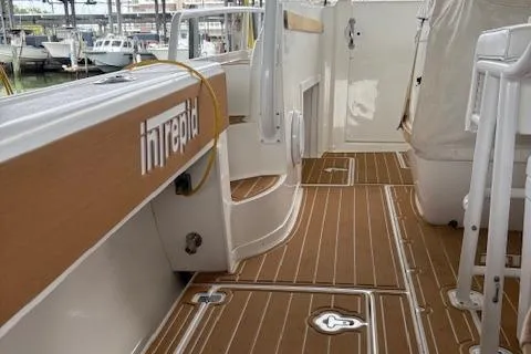Slide: The Image of 2006 Intrepid 310 Walkaround boat docked in a marina, view from the bow. - 26