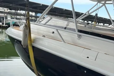 Slide: The Image of 2006 Intrepid 310 Walkaround boat with twin Yamaha 250 engines docked in marina. - 3