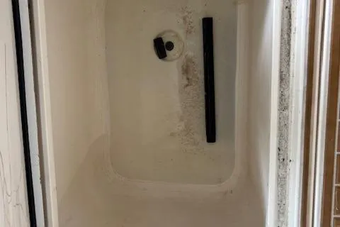 Slide: The Image of 2006 Intrepid 310 Walkaround boat docked in a marina, side view. - 33