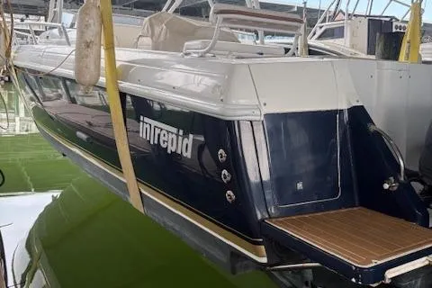 Slide: The Image of 2006 Intrepid 310 Walkaround boat docked in marina, side view. - 4