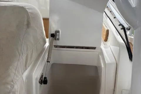 Slide: The Image of 2006 Intrepid 310 Walkaround boat with coiled blue hose on deck. - 44