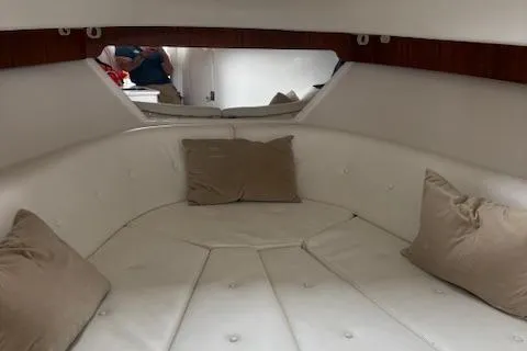 Slide: The Image of 2006 Intrepid 310 Walkaround cabin interior with white seating and beige cushions. - 46