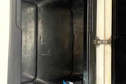 Slide: The Image of 2006 Intrepid 310 Walkaround boat kitchen with sink and storage compartments. - 48