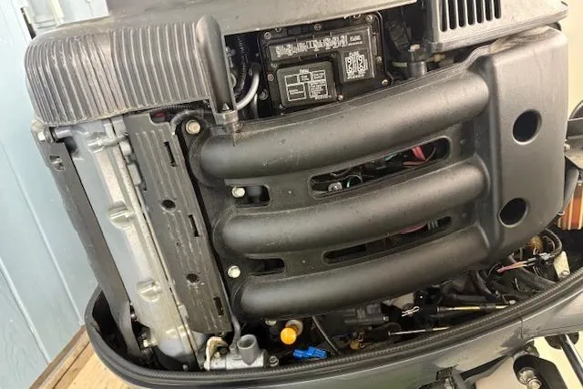 Slide: The Image of 2006 Intrepid 310 Walkaround boat engine compartment with dual outboard motors. - 8