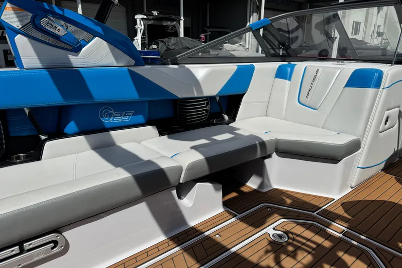 Slide: The Image of 2015 Nautique Super Air Nautique G25 interior with blue and white seating, showcasing luxury design. - 11
