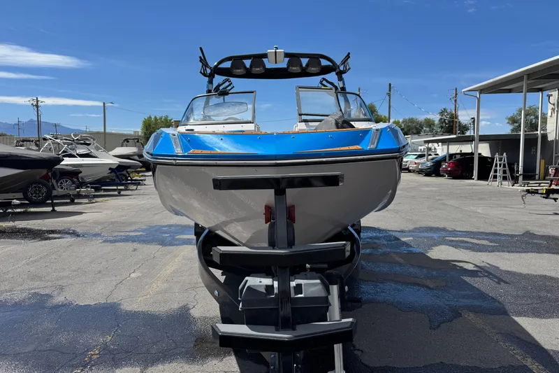 Slide: The Image of 2015 Nautique Super Air Nautique G25 boat on trailer in a marina setting. - 5