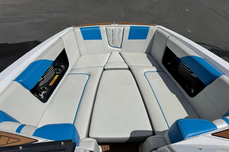 Slide: The Image of 2015 Nautique Super Air Nautique G25 boat interior with white and blue seating. - 6