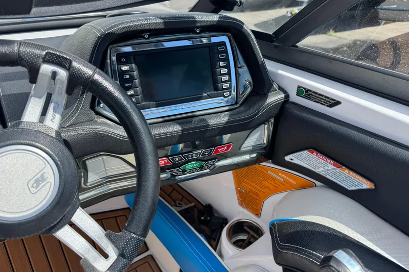 Slide: The Image of Dashboard of 2015 Nautique Super Air Nautique G25 boat with steering wheel and control panel. - 9