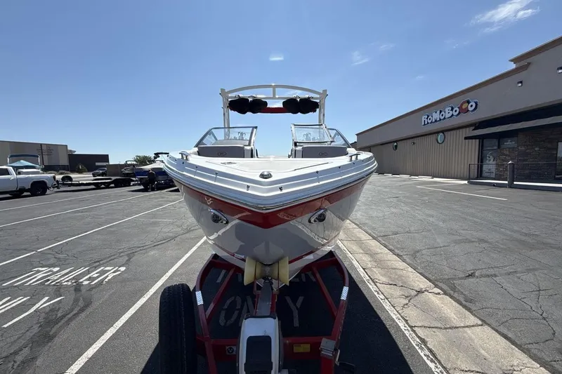 Slide: The Image of 2021 Cobalt R6 Surf boat on trailer in parking lot, front view. - 11