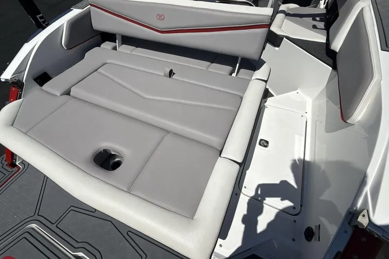 Slide: The Image of 2021 Cobalt R6 Surf boat interior with gray seating and red accents. - 13