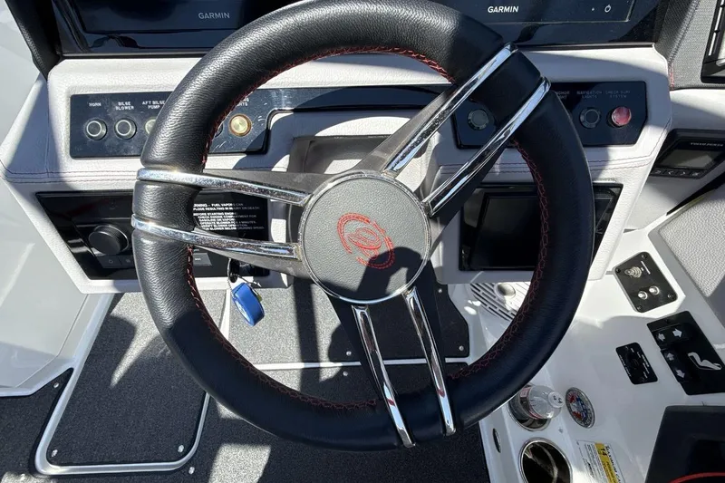 Slide: The Image of Steering wheel of 2021 Cobalt R6 Surf boat with modern dashboard controls. - 17