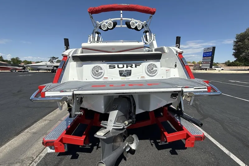 Slide: The Image of 2021 Cobalt R6 Surf boat rear view with red accents and speakers. - 7