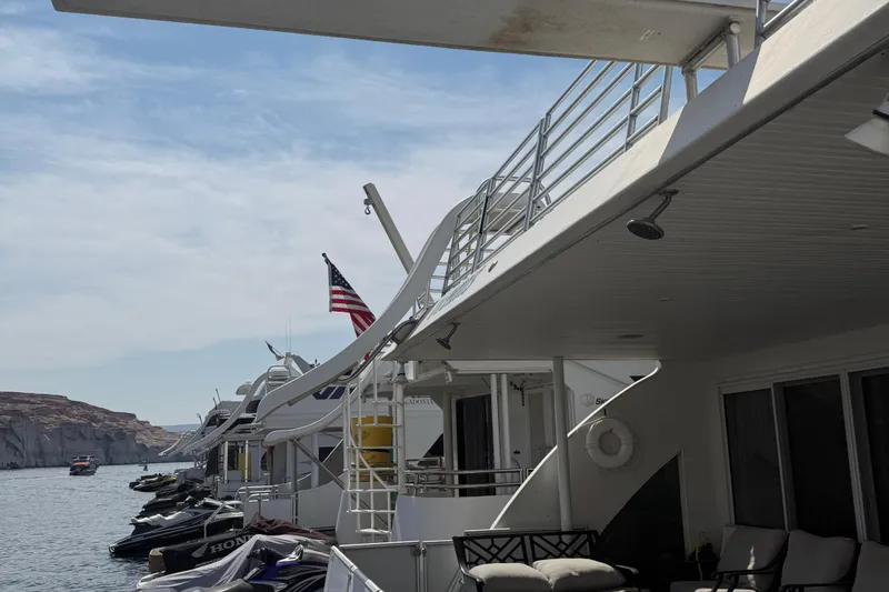 Slide: The Image of Houseboats docked on a serene lake, featuring STARDUST Oceans Share #2, 2015 model. - 10