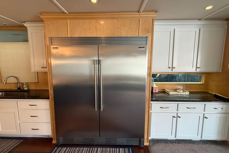 Slide: The Image of Modern kitchen with stainless steel refrigerator, white cabinets, and wooden accents, STARDUST Oceans Share #2, 2015. - 11