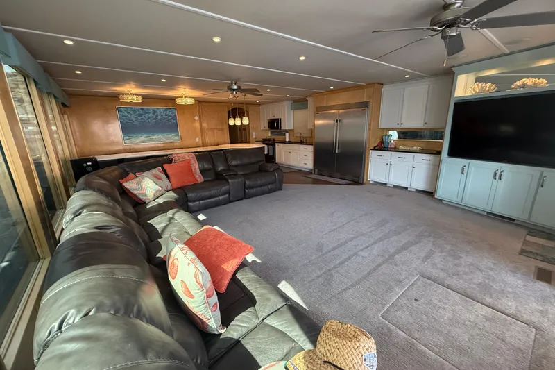 Slide: The Image of Luxurious houseboat interior with leather sectional, modern kitchen, and large TV, STARDUST Oceans Share #2. - 18