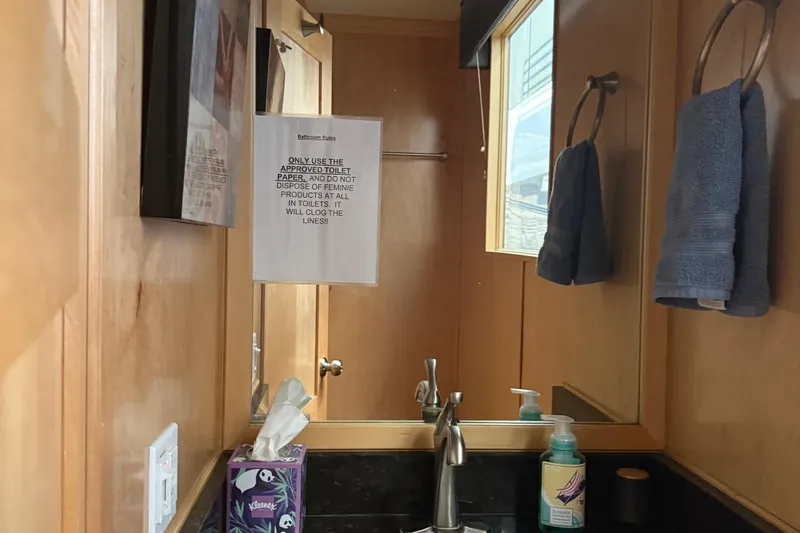 Slide: The Image of Small bathroom with wooden walls, mirror, towels, and hygiene products. STARDUST Oceans Share #2, 2015. - 33