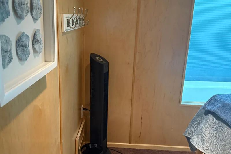 Slide: The Image of Cozy room corner with wall art, hooks, and a standing fan, STARDUST Oceans Share #2, 2015. - 36